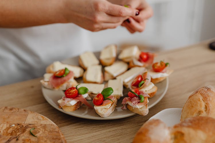 Person Preparing A Platter Of Food