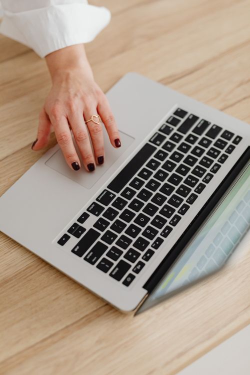 Close Up of Hand and Laptop · Free Stock Photo