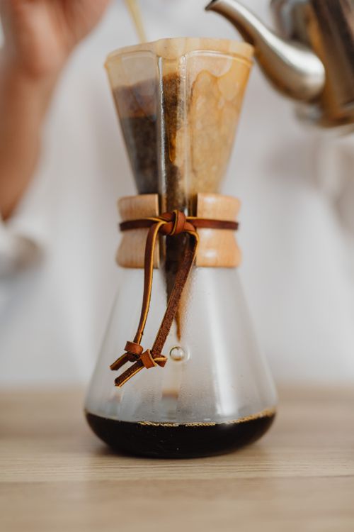 Free Close-up of a freshly brewed pour-over coffee in a Chemex with a leather strap. Stock Photo