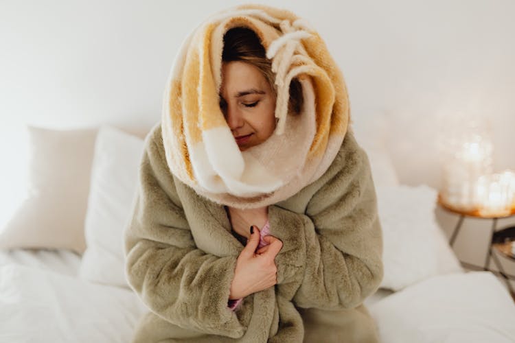 Woman In A Bathrobe And Wrapped In A Blanket