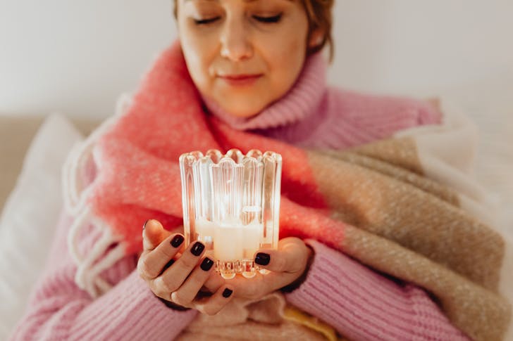 Woman Wrapped in a Blanket Holding a Candle