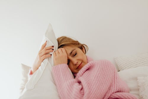 Free A Woman in Pink Turtle Neck Sweater Sleeping Stock Photo