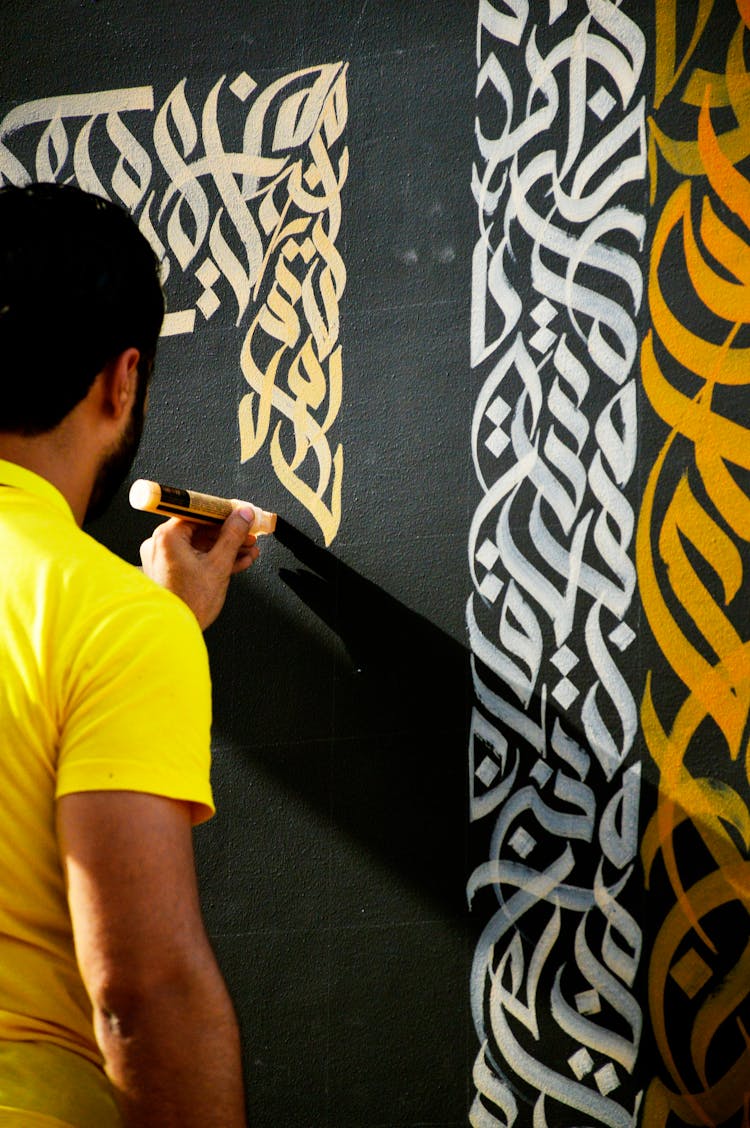 A Man Drawing With Chalk On A Blackboard