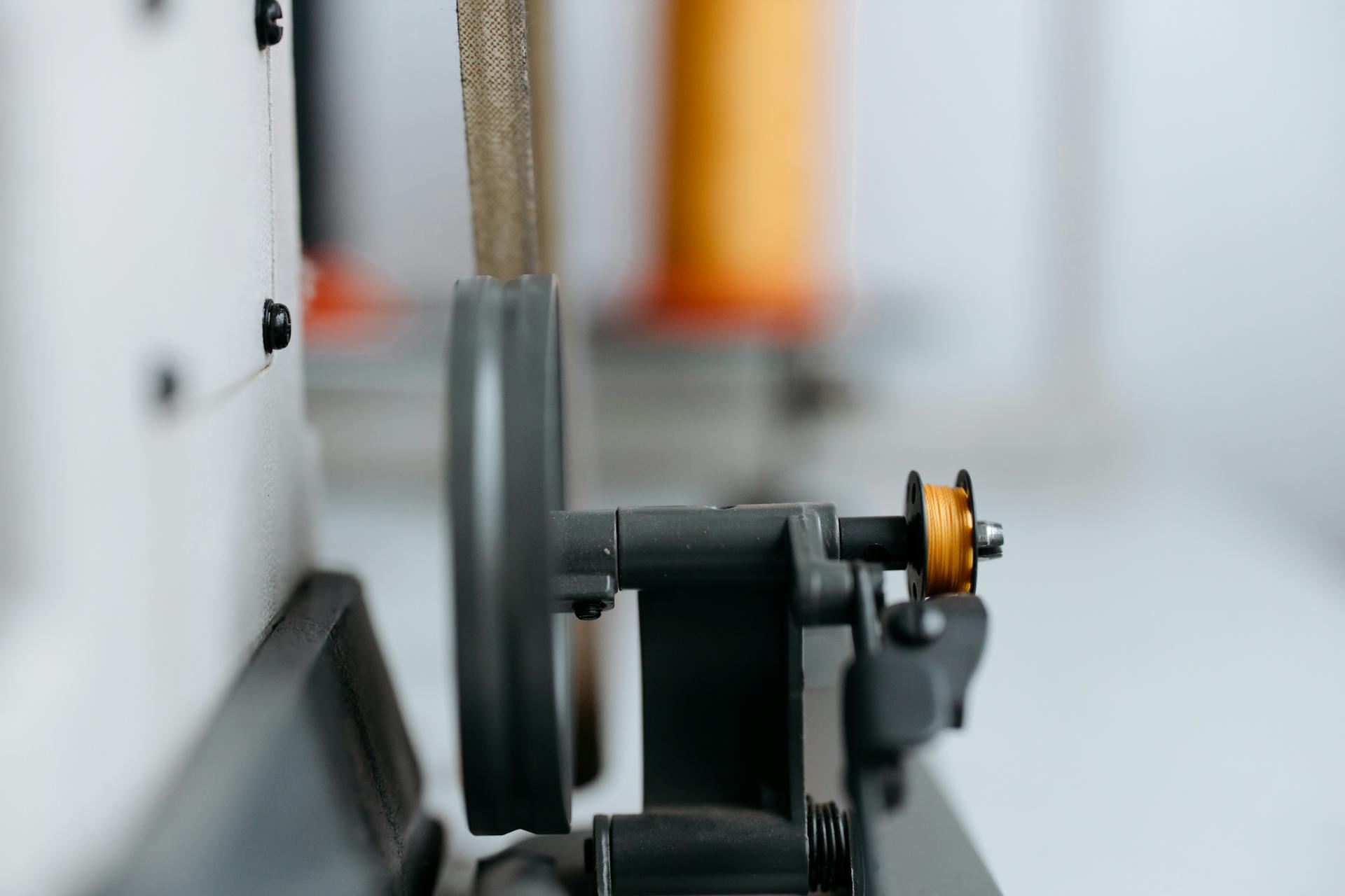 Close-up of contemporary industrial machinery with thread and wheel.