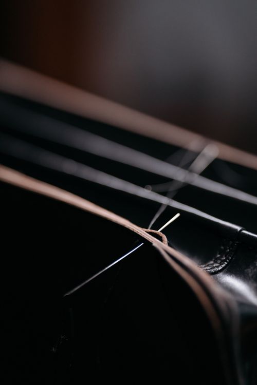 Needle drawn through leather, photo by cottonbro studio on Pexels