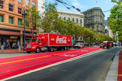 A Red Truck on a Road in a City