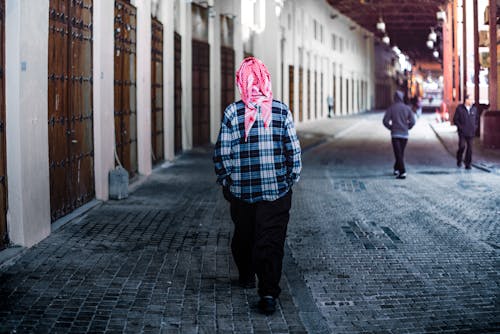 
A Person Wearing a Checkered Shirt Walking