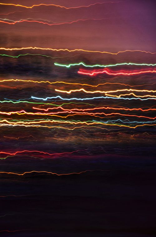 Free Colorful wavy light trails create an abstract and vibrant visual at night. Stock Photo