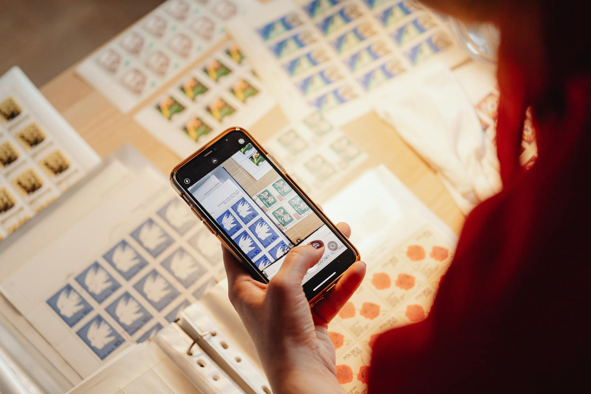 Person Taking Photo of Postage Stamp Using a Smartphone