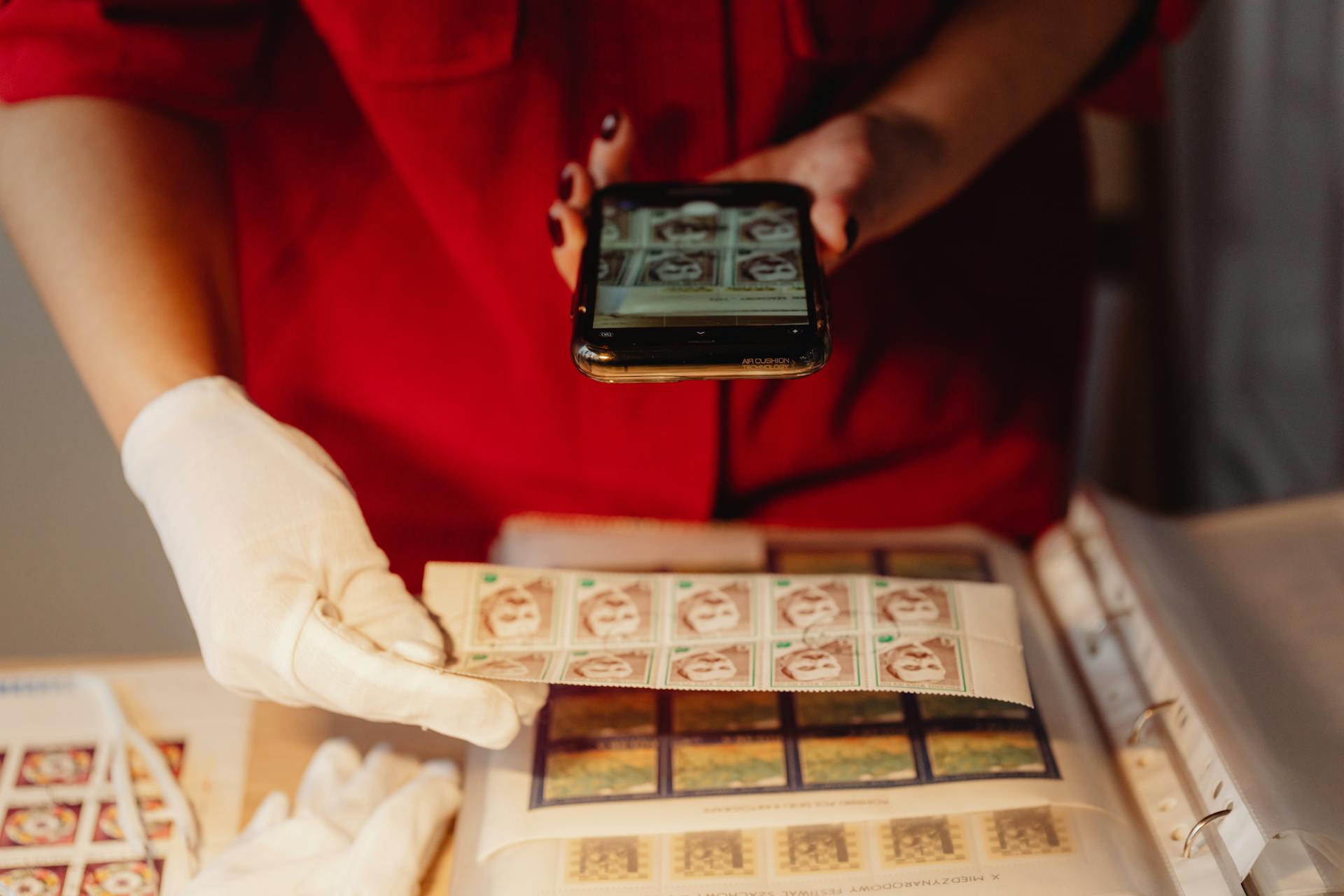 Person Taking Photo of Postage Stamps