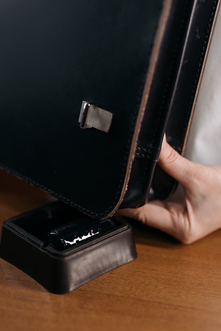 Close Up Of Hand Holding Black, Leather Bag