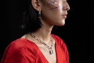 Woman with Face Paint Wearing a Silver Chain Necklace