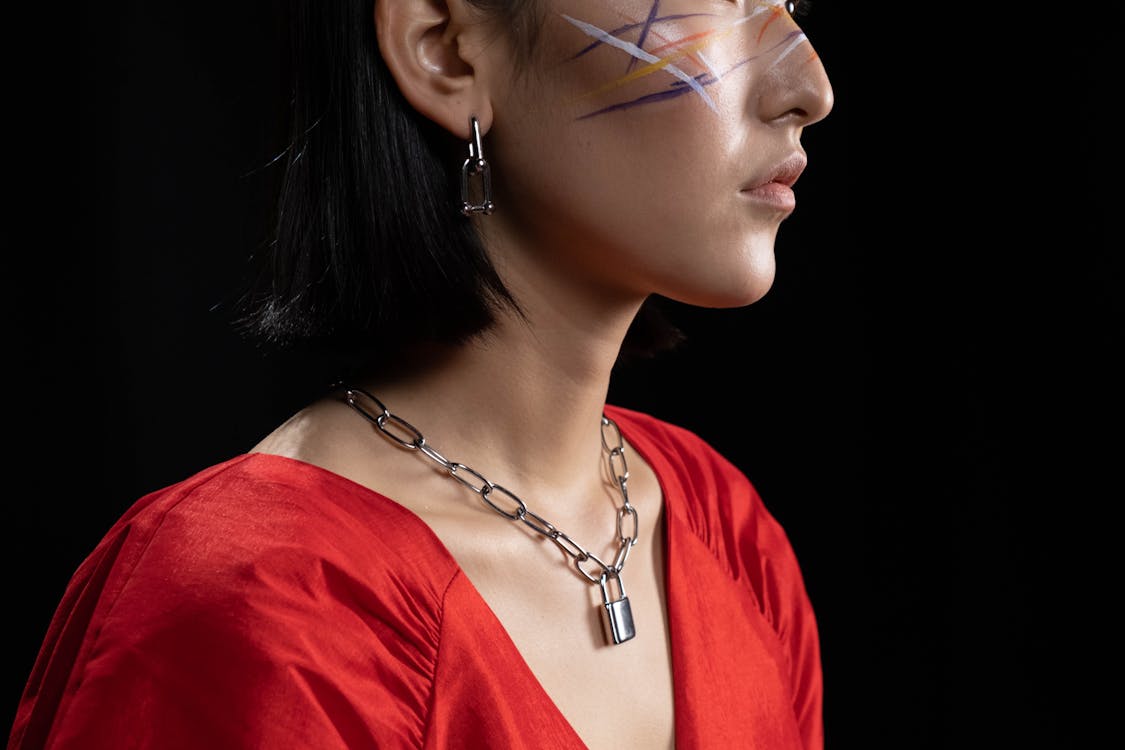 Woman with Face Paint Wearing a Silver Chain Necklace