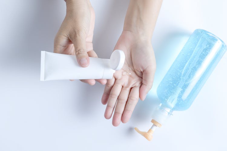 Woman Squeezing Gel From A Tube Onto Her Hand 