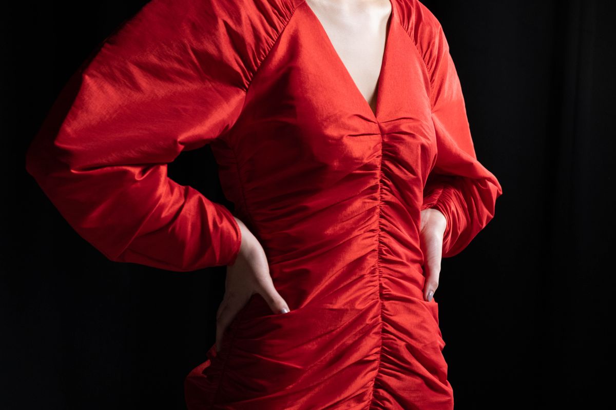 A woman in a red draped mini dress — the romantic register of red