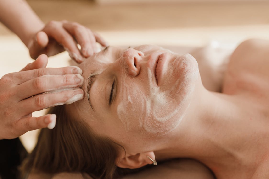 A woman is having a facial treatment in one of the top wellness retreats in Florida