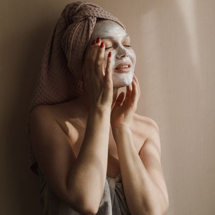 Woman relaxing at home with a facial mask on