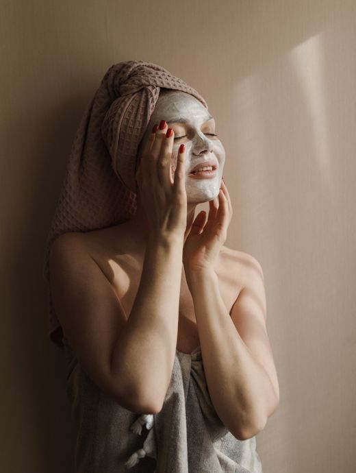 Woman relaxing at home with a facial mask on