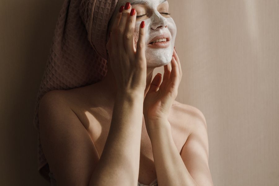 Woman relaxing at home with a facial mask on
