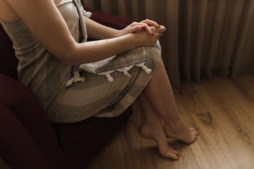 Free A Woman Sitting with Her Legs Crossed Stock Photo