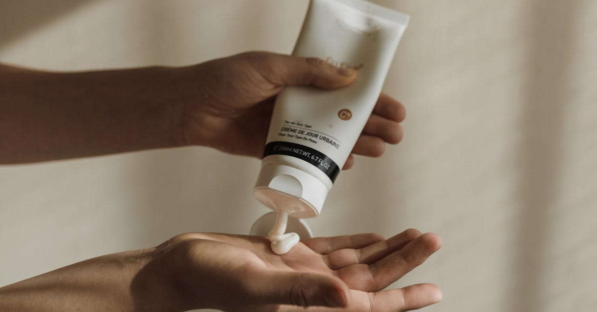 A comparison of a highly-styled, expensive skincare bottle with a basic, clinical-looking tube of moisturizer
