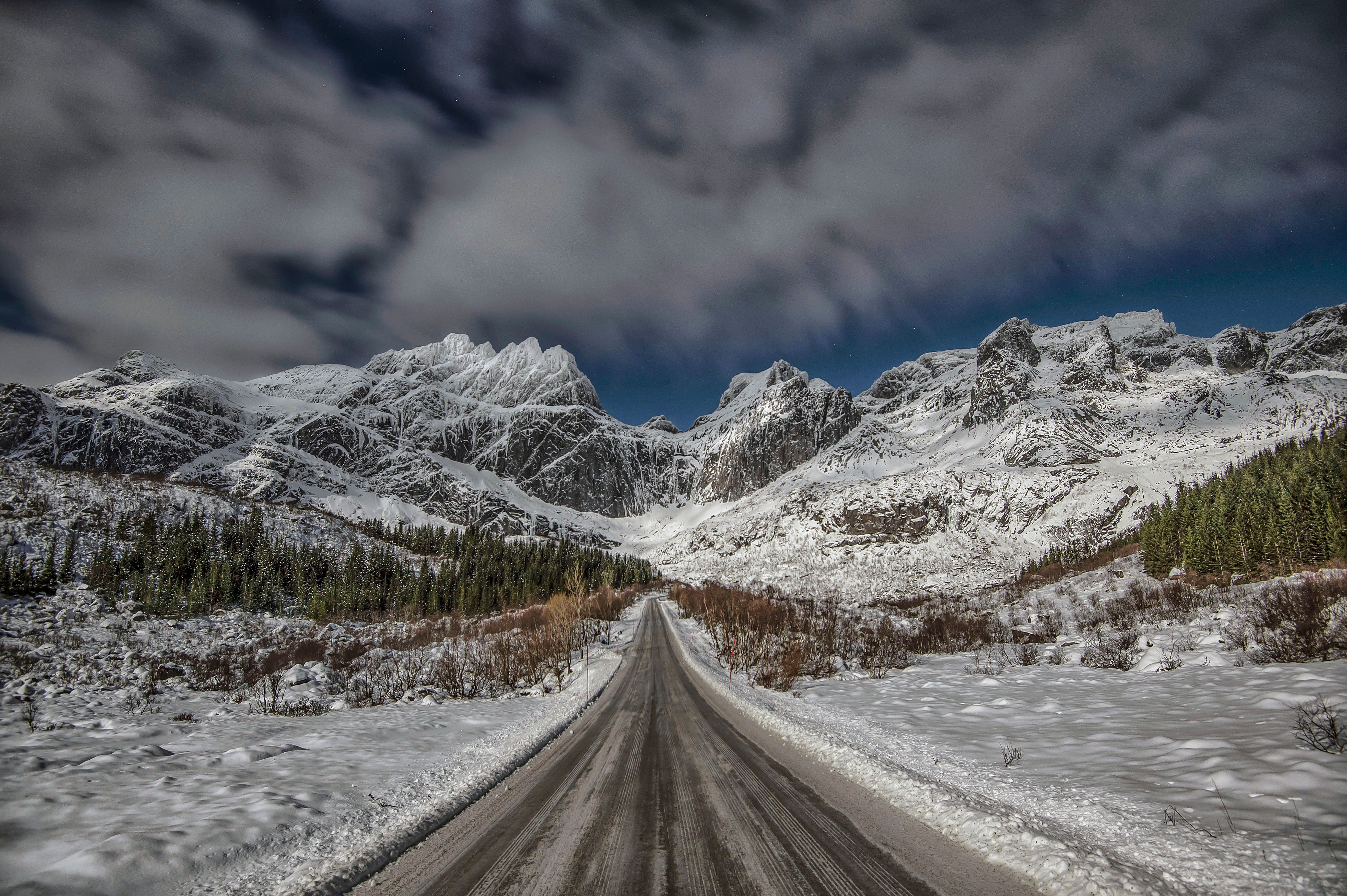 A Road with Snow Covered Mountains in the Background · Free Stock Photo