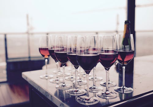 黒いテーブルの上の赤い液体とワイングラス