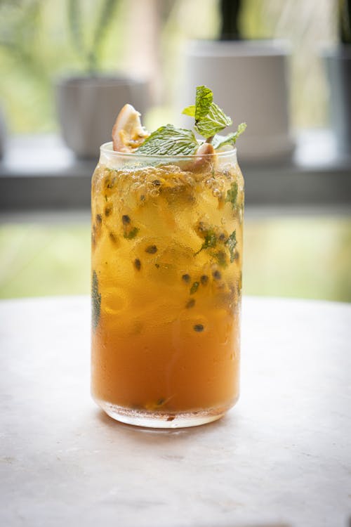 Mojito cocktail with passion fruit seeds in glass
