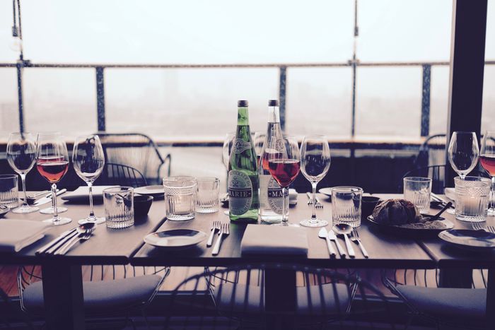 Wine glass on table near silverware