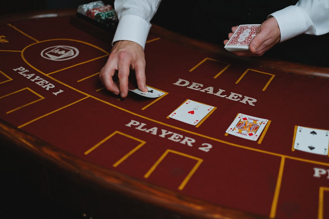 Free Croupier with Cards in Casino Stock Photo