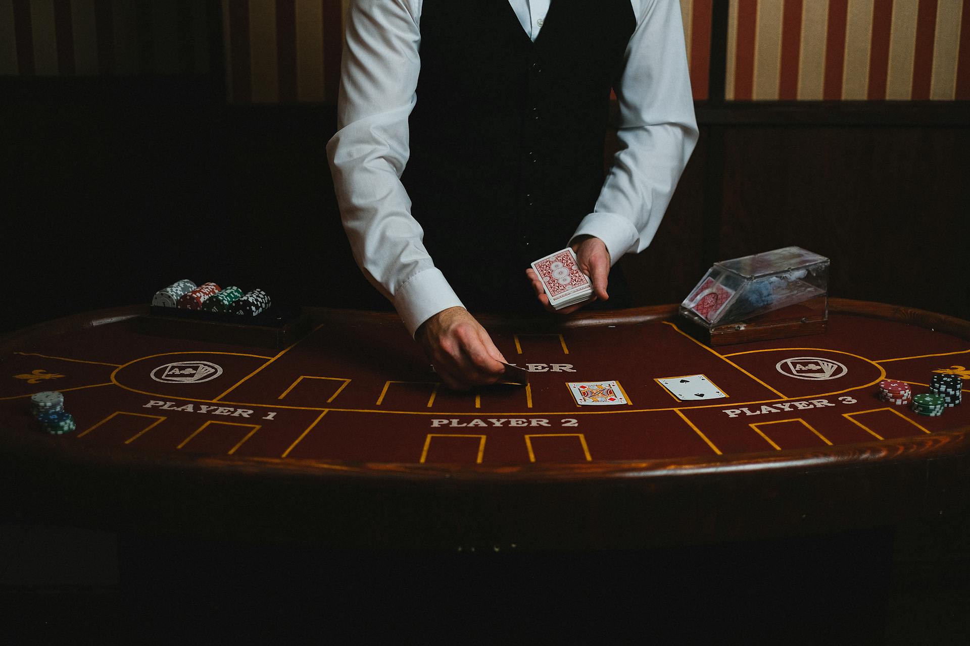 A casino dealer handling cards at a gaming table, ready for blackjack or poker.