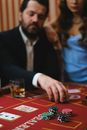 Man in Black Suit Jacket Playing Poker Beside Woman