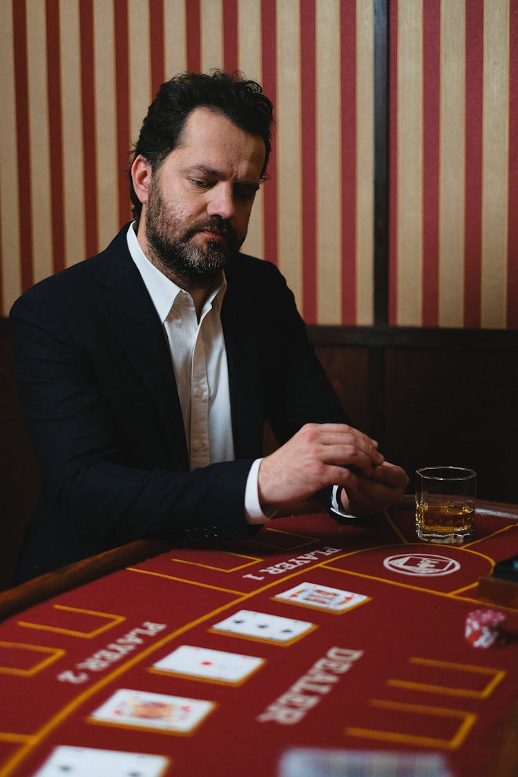 Man In Black Suit Jacket Playing Poker In A Casino