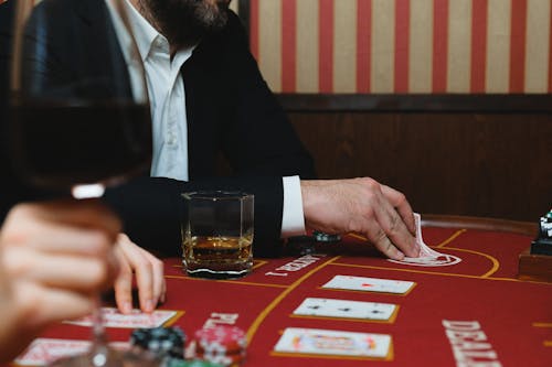 Man in Black Suit Jacket Playing Poker in a Casino