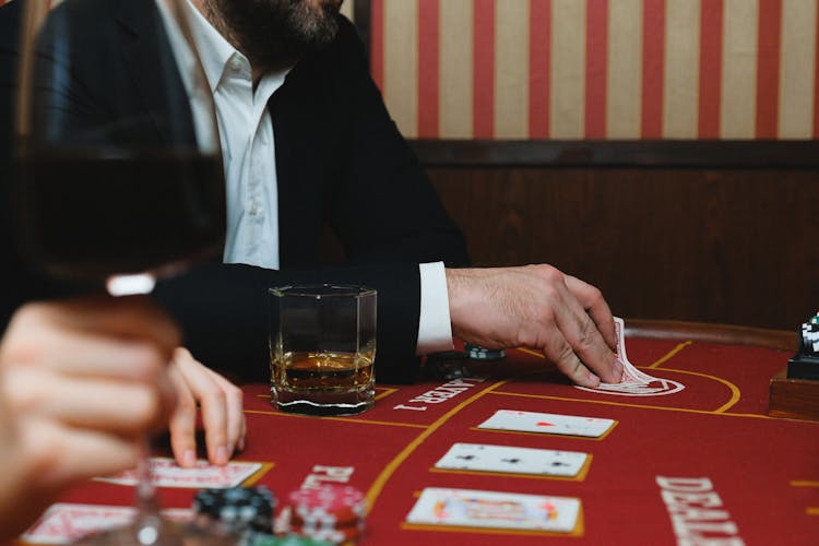 Man In Black Suit Jacket Playing Poker In A Casino