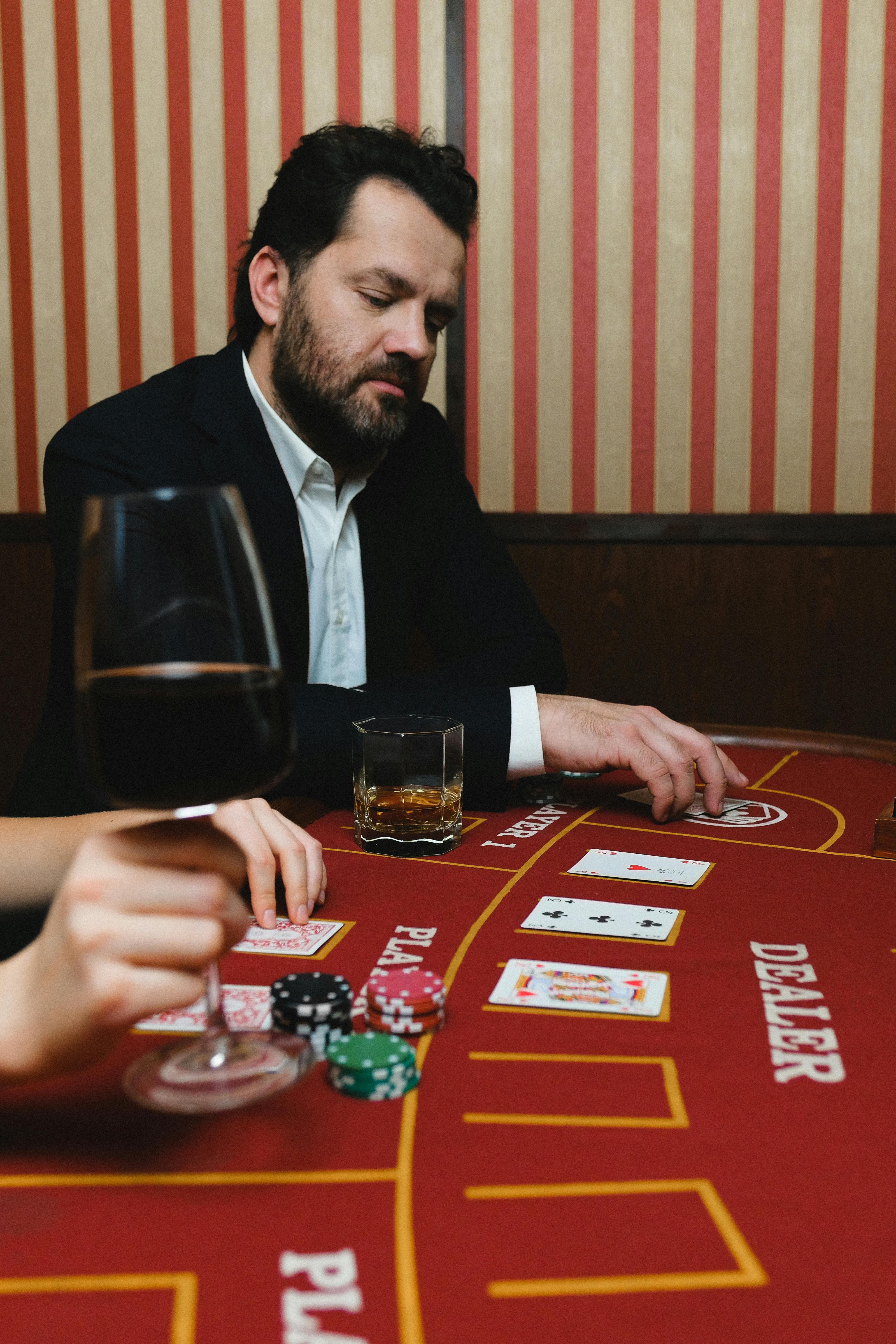 man in black suit jacket playing poker