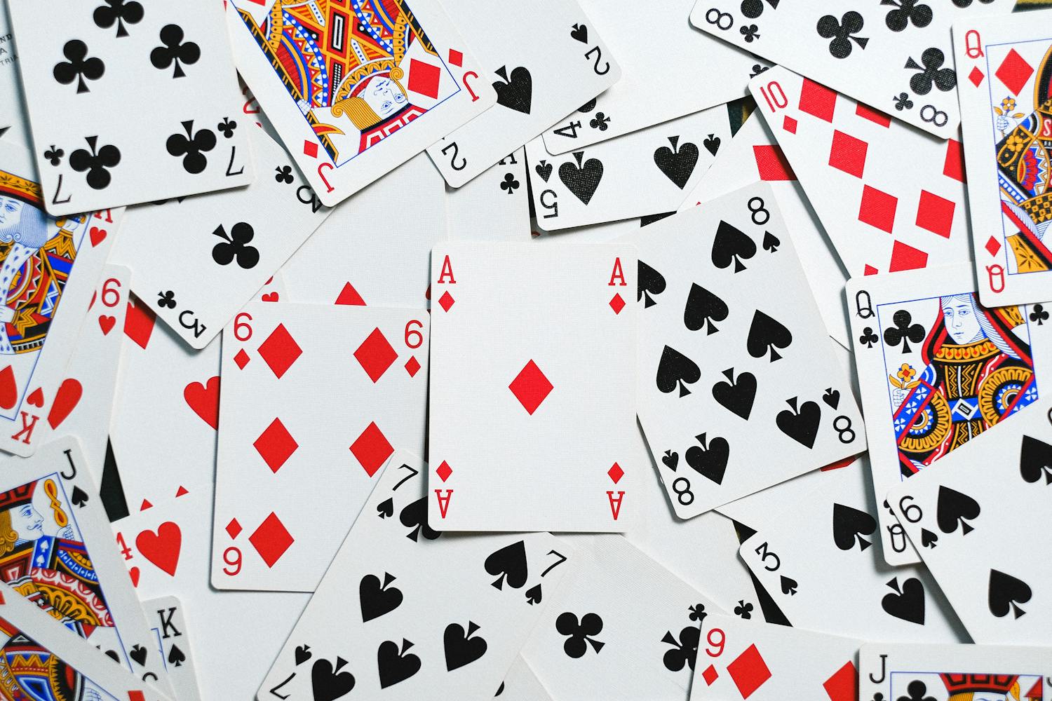 Scattered playing cards showcasing suits and numbers