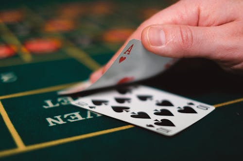 Close-up of Person with Cards in Casino