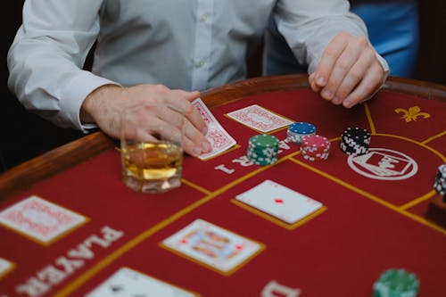 A Person Playing Cards on Casino Table