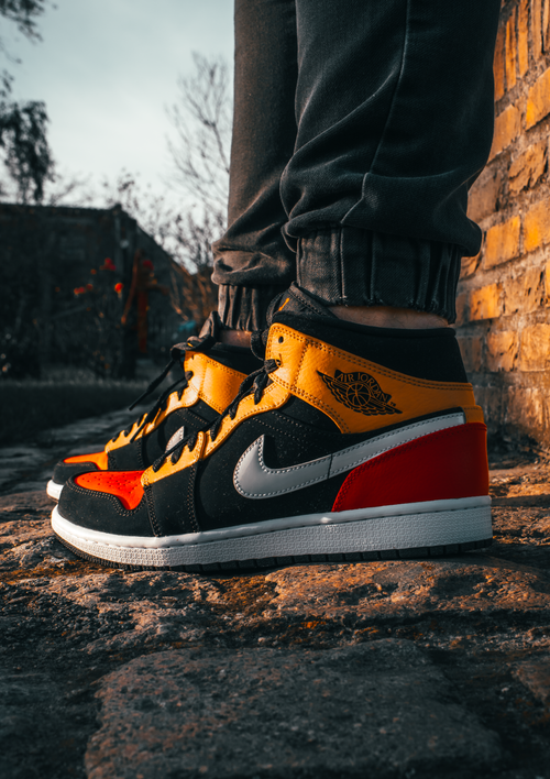 Free Close-up of colorful sneakers on cobblestones at sunset in Moorslede, Belgium. Stock Photo