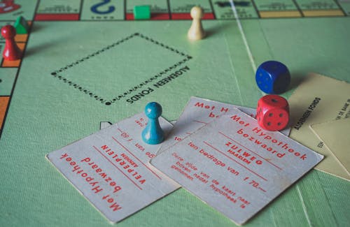 Close Up Photo of Monopoly Game Items 