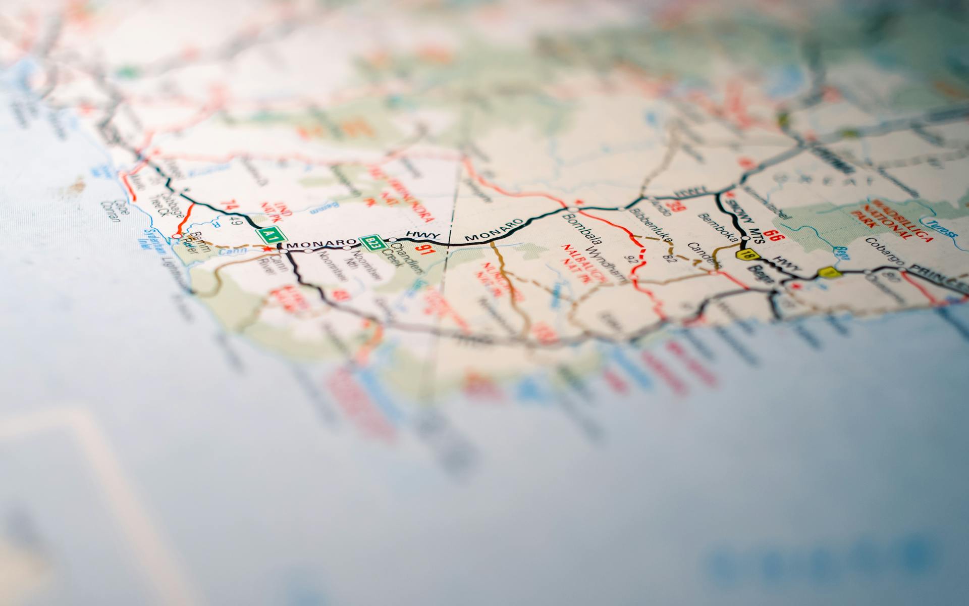 Focus on intricate details of a geographic map, highlighting travel routes.