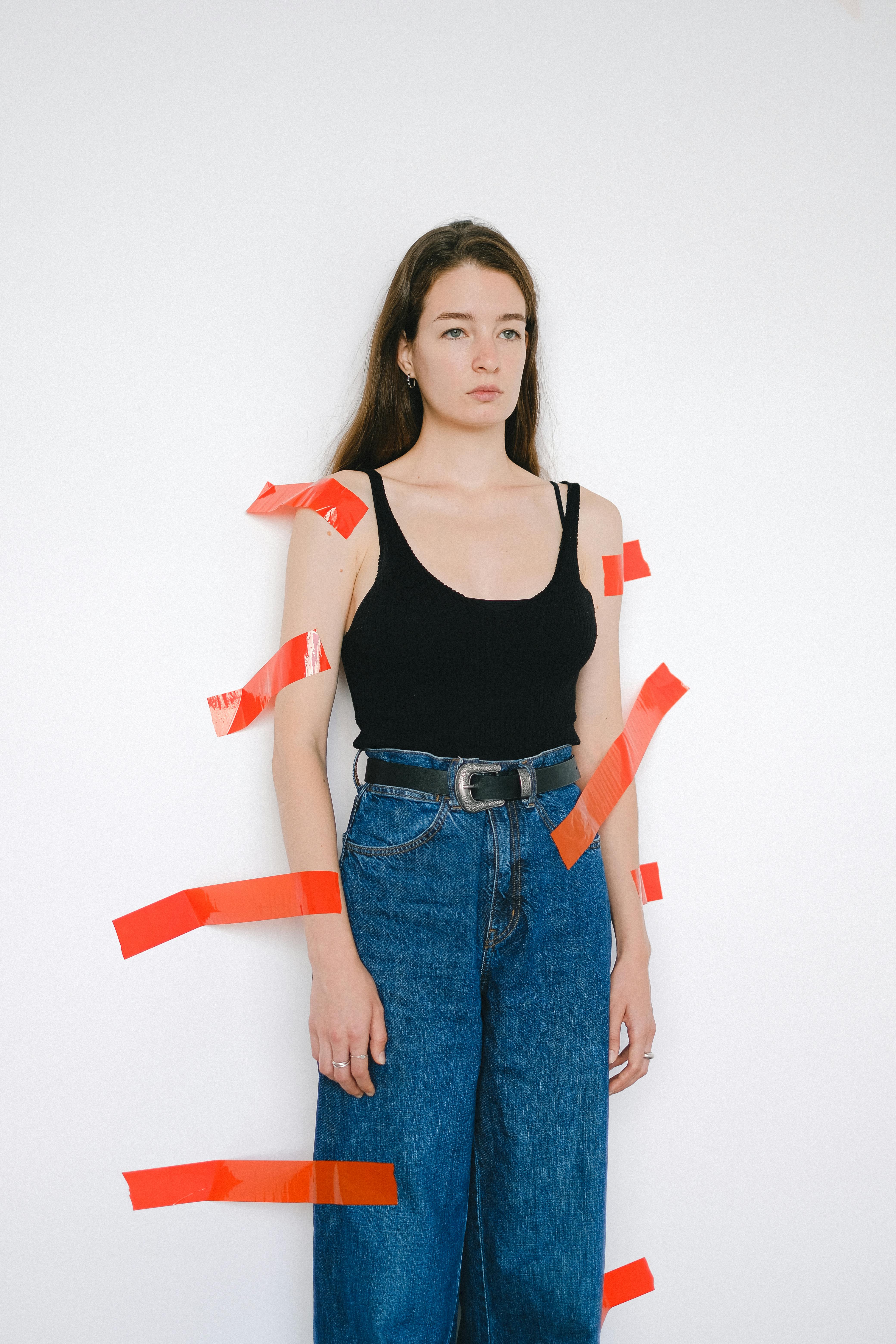 woman in black tank top and blue denim jeans