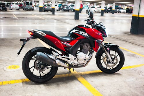 A Red and Black Motorcycle Parked in the Garage