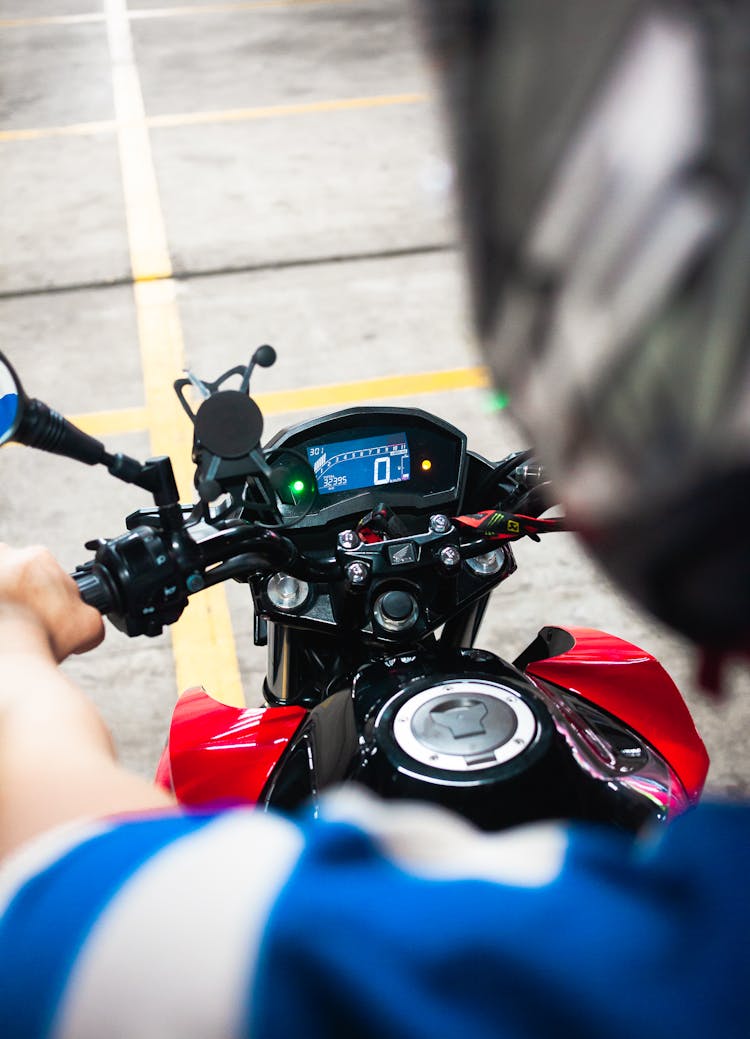 
A Person Riding A Motorcycle With A Digital Gauge Cluster