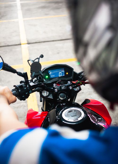 Free Dynamic view from rider's perspective on motorcycle showing digital speedometer and hands on handlebars. Stock Photo