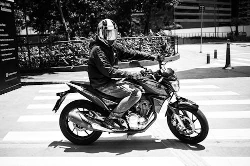 Free 
A Grayscale of a Person Riding a Motorcycle Stock Photo