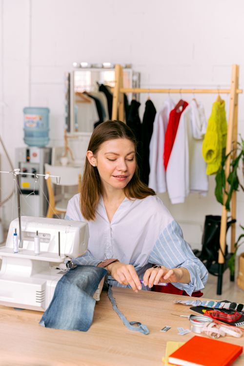 A Woman Using a Sewing Machine · Free Stock Photo
