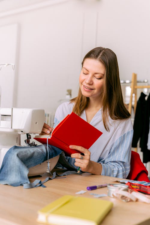 Woman Writing on a Red Notebook