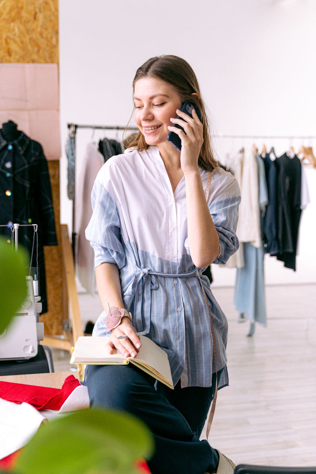 A boutique owner on the phone among the racks